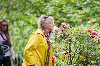 senior woman smelling flowers